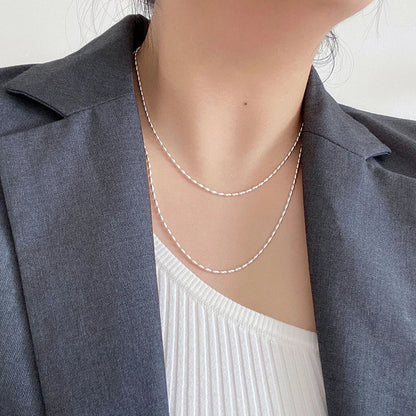 Elegant sterling silver necklace with a geometric zircon pendant sparkling on a delicate 40cm box chain.