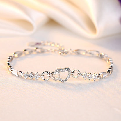 Delicate 925 sterling silver bracelet featuring shimmering purple crystal zircon hearts, perfect for romantic occasions.