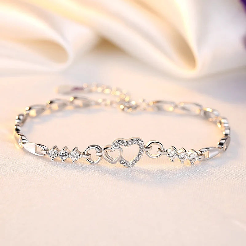 Delicate 925 sterling silver bracelet featuring sparkling purple crystal zircon hearts, perfect for romantic occasions.
