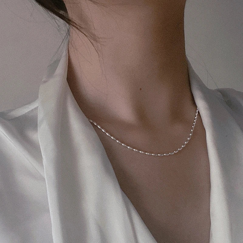 Elegant sterling silver necklace with a geometric zircon pendant, featuring a delicate 40cm box chain and sparkling details.