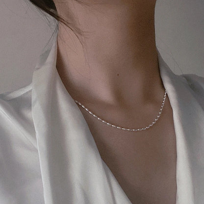 Elegant sterling silver necklace with a geometric zircon pendant, featuring a delicate 40cm box chain and sparkling details.
