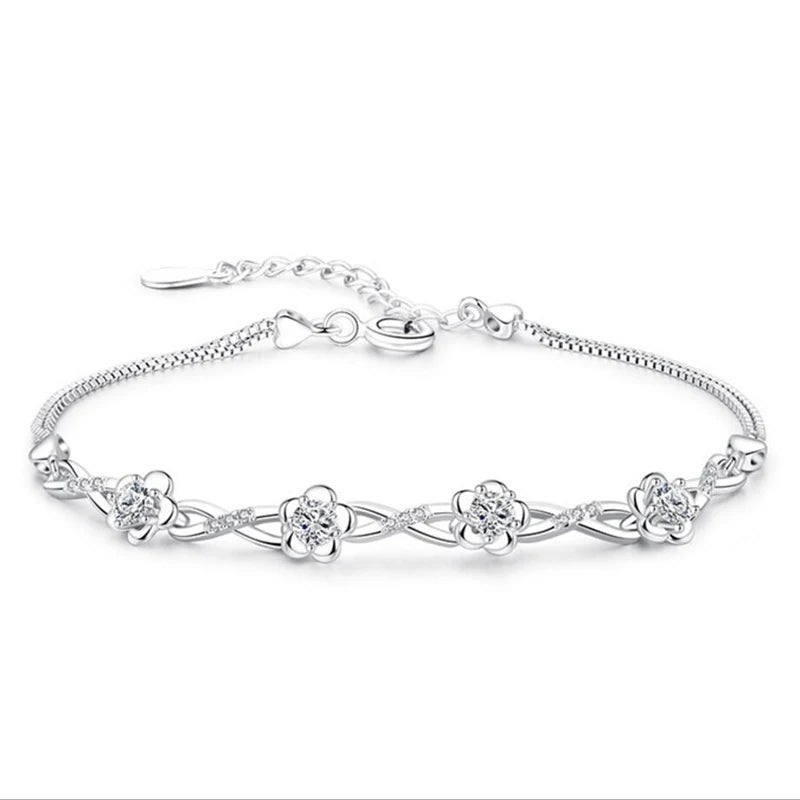 Delicate 925 sterling silver bracelet with a plant motif, sparkling cubic zirconia, and crystal accents for elegant style.