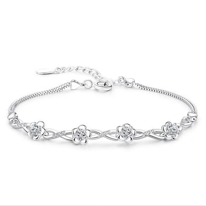 Delicate 925 sterling silver bracelet with a plant motif, sparkling cubic zirconia, and crystal accents for elegant style.