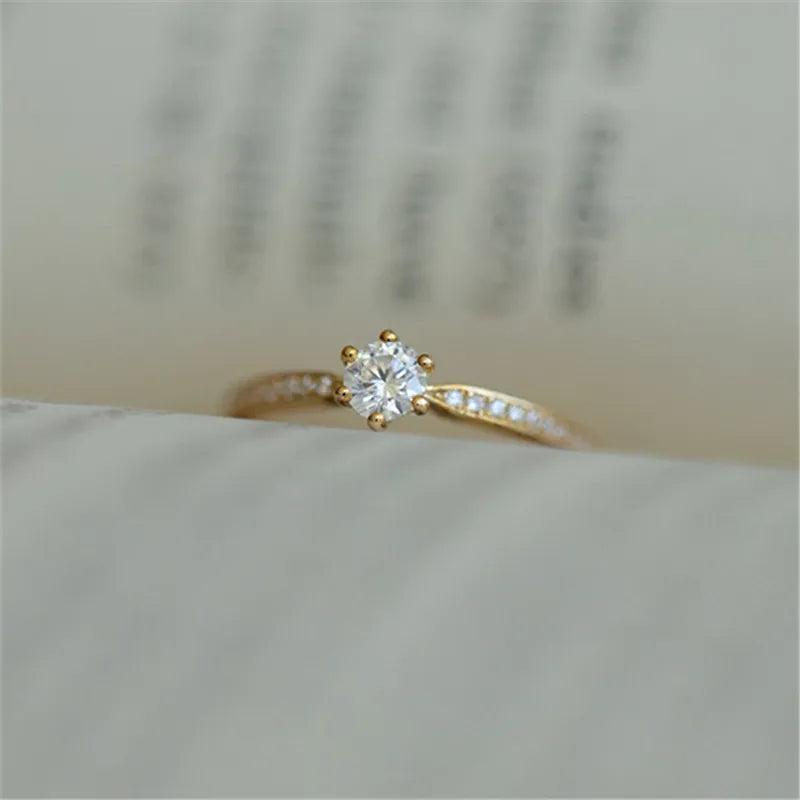 Elegant 925 sterling silver ring plated in 14K gold, featuring a sparkling 4mm zircon stone in a geometric 2mm band.