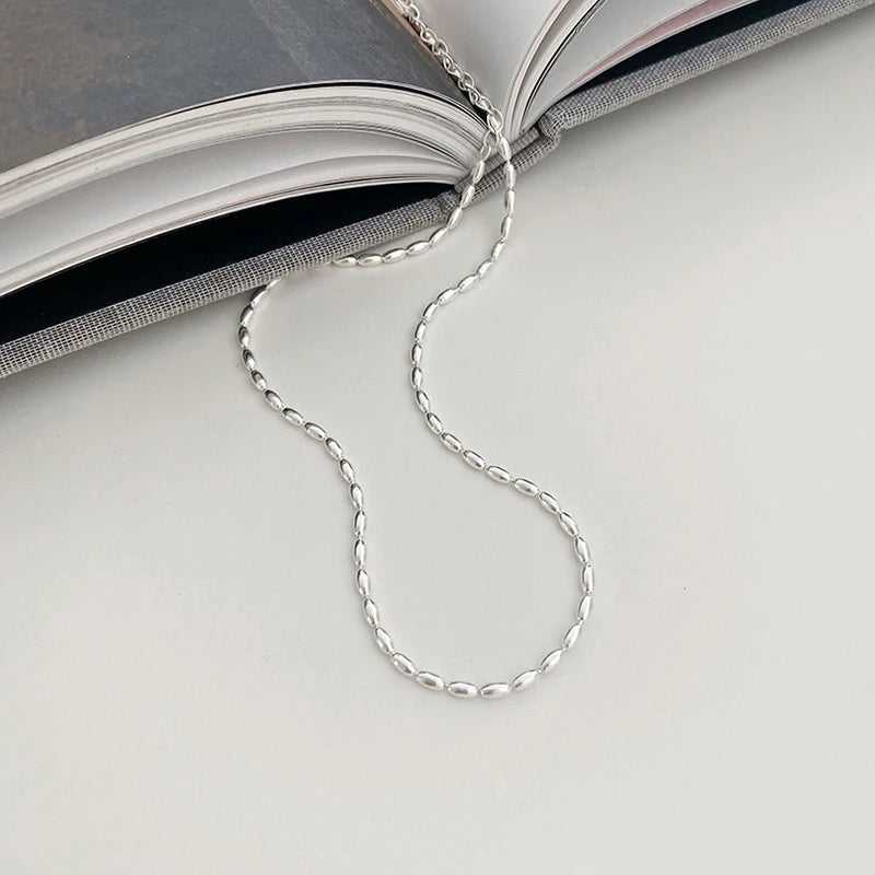 Elegant sterling silver necklace with a geometric zircon pendant sparkling on a delicate 40cm box chain.
