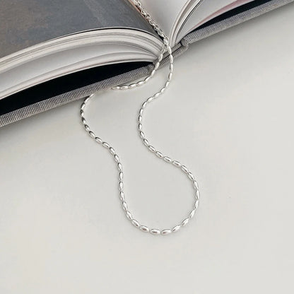 Elegant sterling silver necklace with a geometric zircon pendant sparkling on a delicate 40cm box chain.