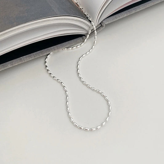 Elegant sterling silver necklace with a geometric zircon pendant sparkling on a delicate 40cm box chain.