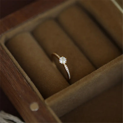Elegant 925 sterling silver ring plated in 14K gold, featuring a sparkling 4mm zircon stone in a geometric 2mm band.