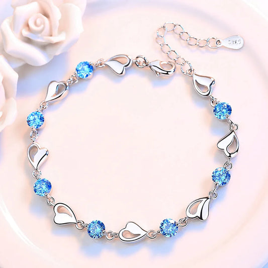 Delicate 925 sterling silver bracelet with sparkling zircon crystals forming a charming heart-shaped design.
