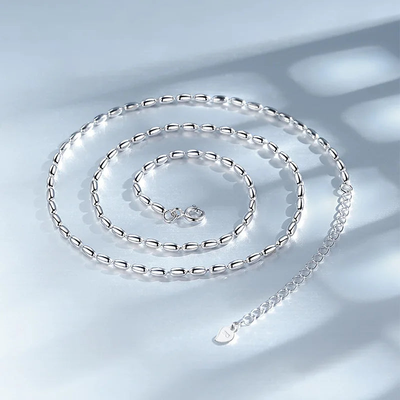 Delicate sterling silver necklace with a geometric zircon pendant, featuring a shimmering precision-cut stone on a 40cm box chain.