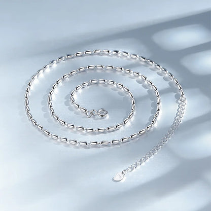Delicate sterling silver necklace with a geometric zircon pendant, featuring a shimmering precision-cut stone on a 40cm box chain.