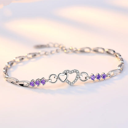 Delicate 925 sterling silver bracelet with shimmering purple crystal zircon hearts, perfect for romantic occasions.