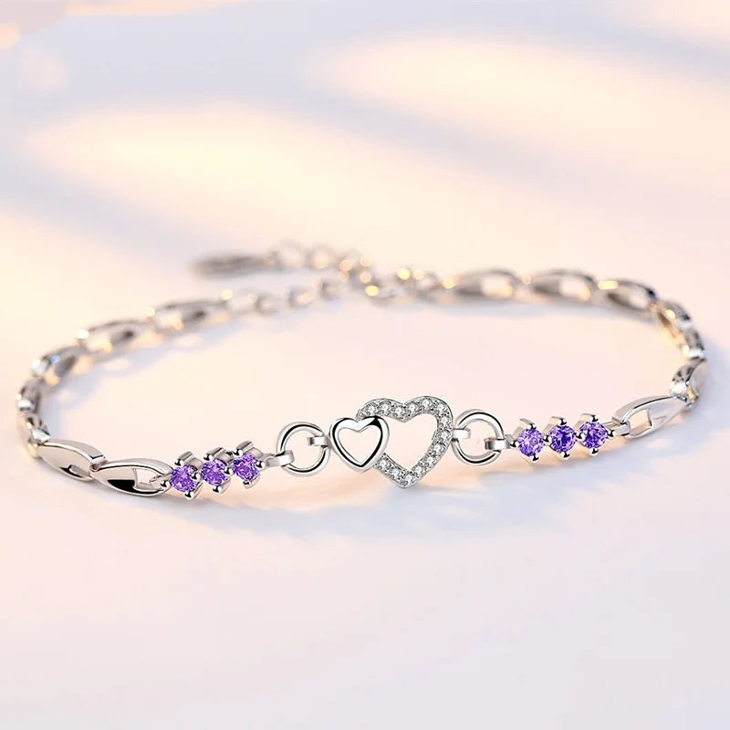 Delicate 925 sterling silver bracelet featuring shimmering purple crystal zircon hearts, perfect for romantic occasions.