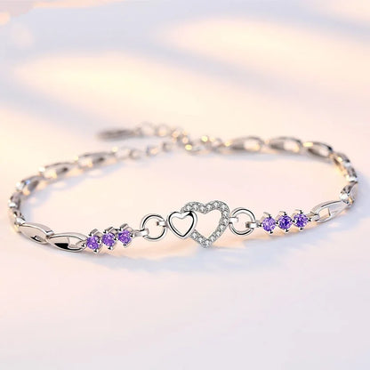 Delicate 925 sterling silver bracelet featuring shimmering purple crystal zircon hearts, perfect for romantic occasions.