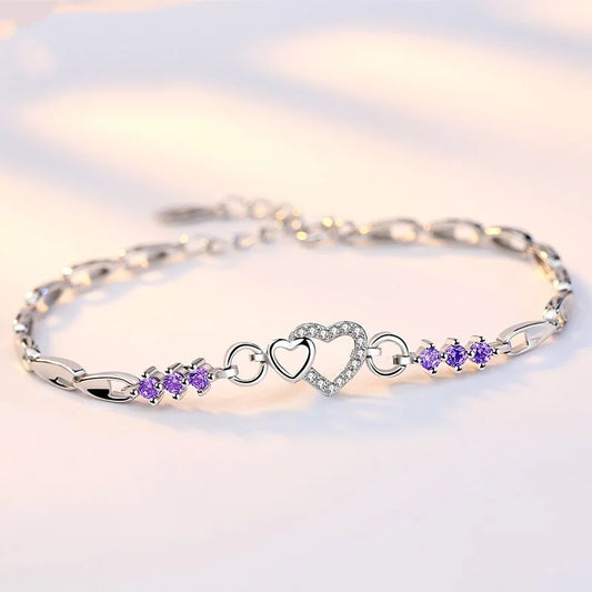 Delicate 925 sterling silver bracelet featuring shimmering purple crystal zircon hearts, perfect for romantic occasions.