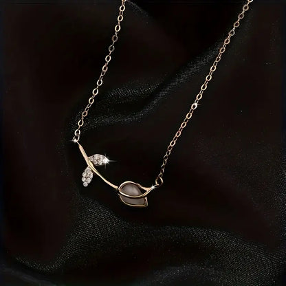 Delicate 925 sterling silver necklace with a tiny botanical pendant featuring a plant motif and sparkling zircon accent.