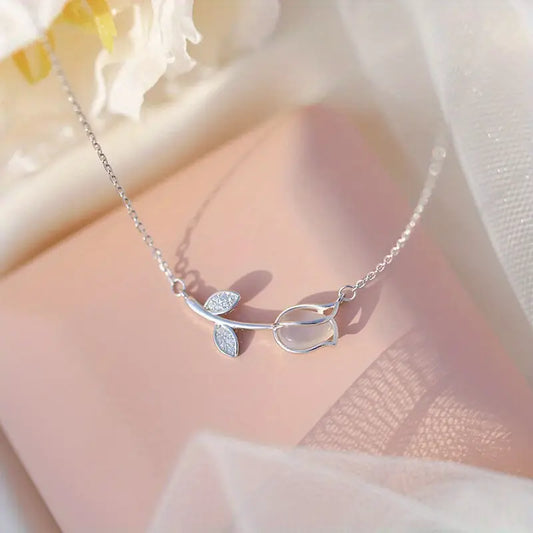 Elegant 925 sterling silver necklace with a tiny botanical pendant featuring a sparkling zircon accent and adjustable chain.