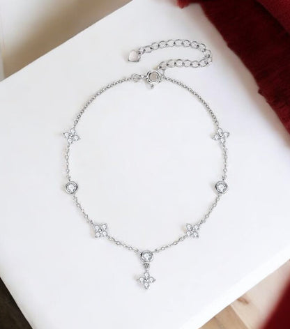 Elegant 925 sterling silver bracelet with sparkling D-colour moissanite stones in a four-leaf flower geometric design.